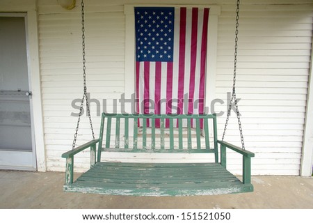 Barstow, California - Circa 2005: Old Swing On Porch Displaying An American Flag And Patriotic Theme Near Barstow Ca Off Route 60
