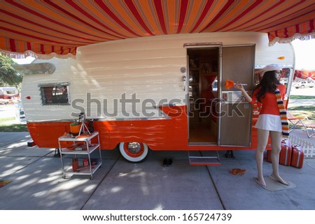 Exterior view of 1960 Orange and White Shasta Trailer, at Vintage Trailers and Campers, the 4th Annual Vintage Trailer Bash, Flying Flag RV Resort, Buellton, California September 2013