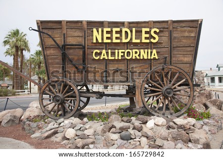 Covered wagon welcomes drivers to Needles California sign and Route 66, California