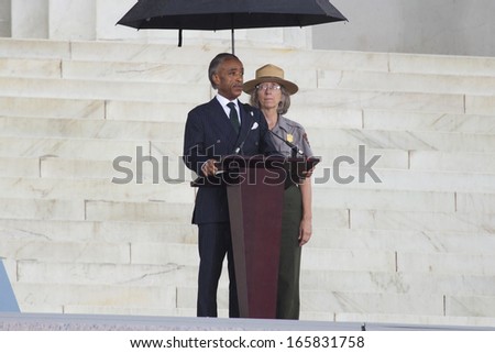 Reverend Al Sharpton, MSNBC TV Host stands under an umbrella and speaks during the Let Freedom Ring, Lincoln Memorial August 28, 2013 in Washington, DC, the 50th anniversary Martin Luther King speech