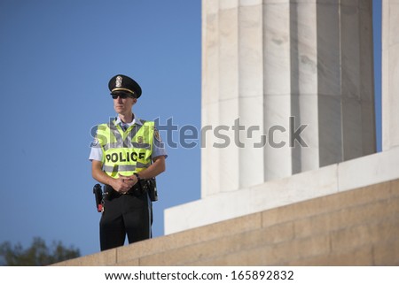 policeman walks in front of statue for Lincoln at the 50th Anniversary of the march on Washington and Martin Luther King\'s Speech, August 24, 2013, Lincoln Memorial, Washington, D.C.