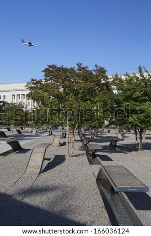 Airplane appears to fly into the Pentagon Memorial which features 184 empty benches, a Memorial to commemorate the anniversary of the September 11, 2011 attacks in Arlington VA., Washington, DC, USA.