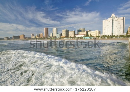 Ocean wave comes in Durban skyline, South Africa on the Indian Ocean