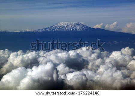 Aerial image of Mount Kilimanjaro, Africa\'s highest mountain, with snow and white puffy clouds from Kenya