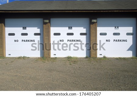 No Parking signs on a garage door