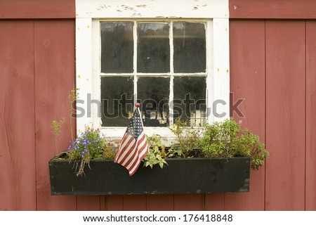 American flag displayed in flower pot of house window off of Manchester Road, St. Louis County, Missouri