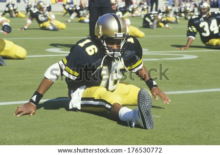 Football Player stretching on field prior to Homecoming Game, West Point, NY
