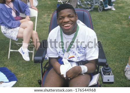 Handicapped African American Athlete cheering at finish line, Special Olympics, UCLA, CA