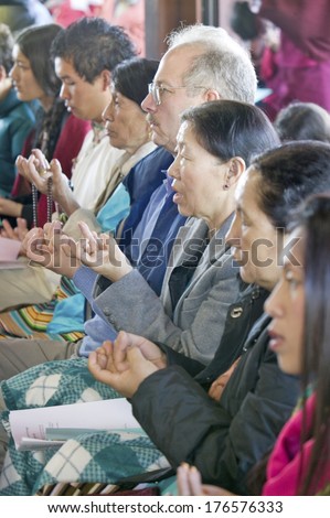 Devotees hold prayer beads and rice during an Amitabha Empowerment Buddhist Ceremony, Meditation Mount in Ojai, CA
