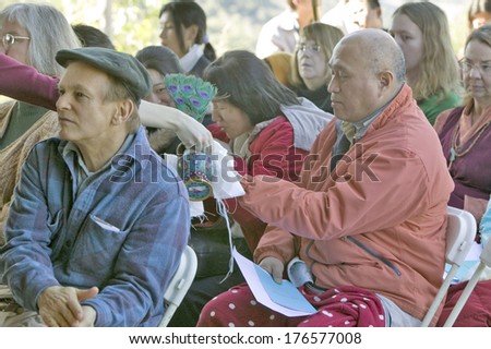 Devotee receives tea from the a ritual vase at Amitabha Empowerment Buddhist Ceremony, Meditation Mount in Ojai, CA