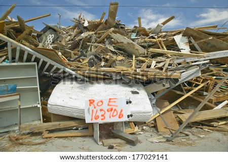 Street address and debris in front of house heavily hit by Hurricane Ivan in Pensacola Florida