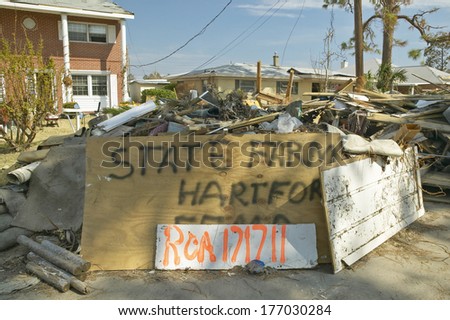 State Farm Insurance Agency sign and debris in front of house heavily hit by Hurricane Ivan in Pensacola Florida