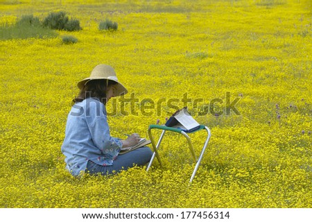 An artist using her colored pencils to sketch the colorful spring flower fields off of Highway 58, central CA