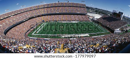 This is Mile High Stadium with the Denver Broncos playing the St. Louis Rams to a sold out crowd. This was an NFL game that took place on 9/14/97. The final score was Denver 35, St. Louis 14.