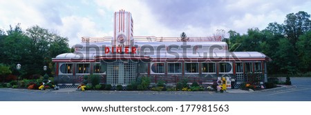 This is the Eveready Diner. It is a 50\'s style diner whose building looks similar to an old train car. The roof is made from a silver chrome with windows all across the front.