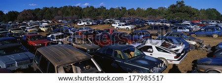 This is an auto salvage yard. The cars here are either crashed vehicles or no longer in use. They are wrecks all parked side by side.