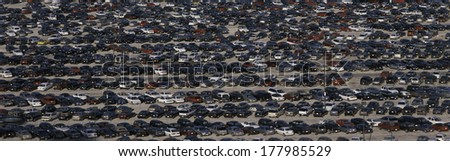 This is a commuter parking lot across from Manhattan or New York, New York. There are rows and rows of cars parked side by side.
