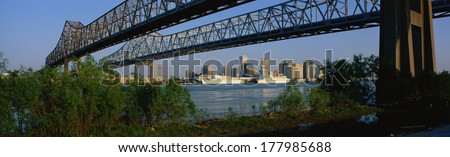 These are the Twin Bridges to New Orleans along the Mississippi River. In the background is the skyline in morning light.