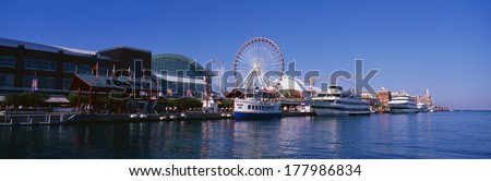 This is Navy Pier with its working Ferris wheel and summer tour boats docked next to it in Lake Michigan.