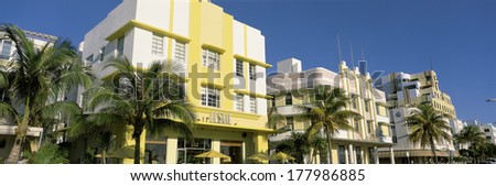 This is the art deco district of South Beach Miami. The buildings are painted in pastel colors surrounded by tropical palm trees.