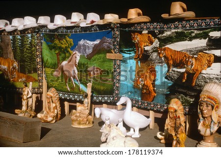 Carpets, cowboy hats and ceramics for sale at a roadside stand, San Joaquin CA