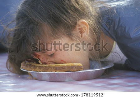 Teenage girl in a pie-eating contest, Knott\'s Berry Farm, CA