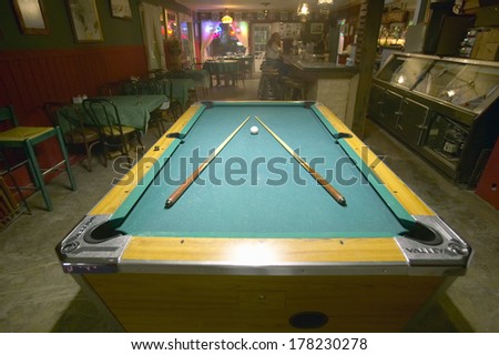 Pool table lit by electric lights in a restaurant and bar in Shoshone, CA near Death Valley National Park