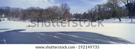 Panoramic view of frozen pond in Central Park, Manhattan, New York City, NY after winter snowstorm
