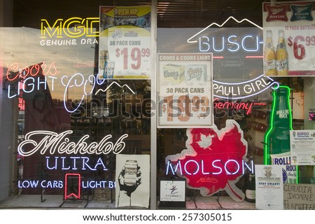Beer signs in neon in liquor store window of Connecticut