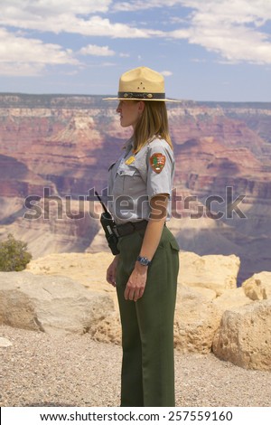 Male National Park ranger looking at South Rim of Grand Canyon National Park in mid-summer in Arizona