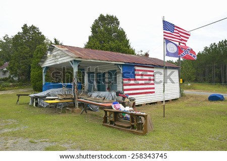 Rustic dwelling with American and Confederate flags along Highway 22 in Central Georgia