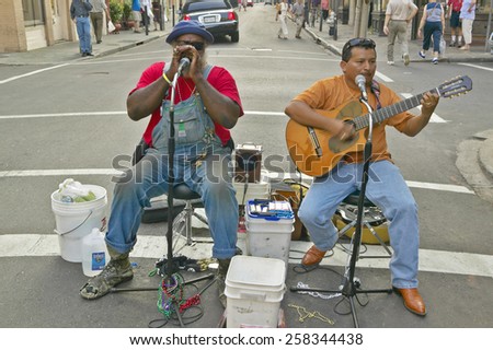 Two musicians perform in street of French Quarter near Bourbon Street in New Orleans, Louisiana