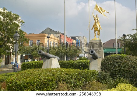 Canons and French Golden statue in French Quarter of New Orleans, Louisiana