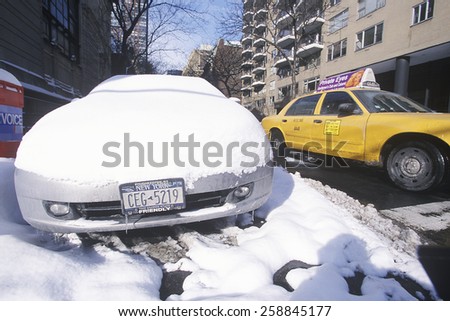 Snow covered car in streets of Manhattan, New York City, NY after winter snowstorm