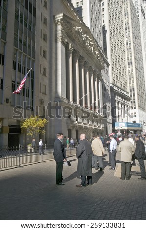 Stock traders take a break in front of the New York Stock Exchange on Wall Street, New York City, New York