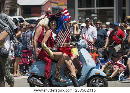 Men in drag on motor scooter celebrate July 4, Independence Day Parade, Telluride, Colorado, USA, 04.07.2014
