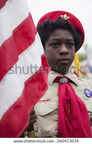 African American Female Boyscout display US Flag at solemn 2014 Memorial Day Event, Los Angeles National Cemetery, California, USA, 05.24.2014