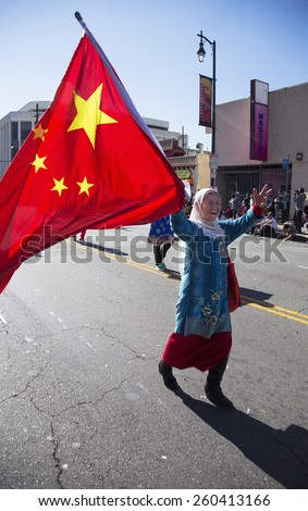 Woman displays Chinese flag at Chinese New Year parade, 2014, Year of the Horse, Los Angeles, California, USA, 02.01.2014