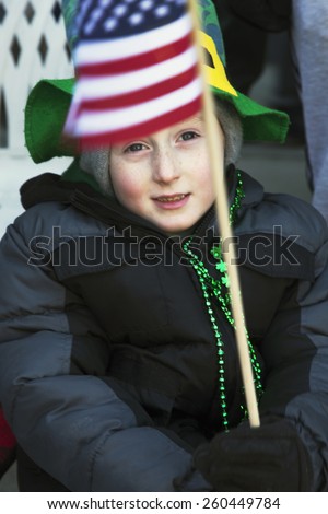 Child holds US Flag, St. Patrick\'s Day Parade, 2014, South Boston, Massachusetts, USA, 03.16.2014