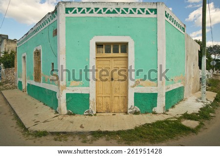 Old Mexican village of Celestun on Gulf of Mexico with old green building storefront