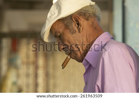 A Cuban man smoking a cigar in El Rincon, Cuba