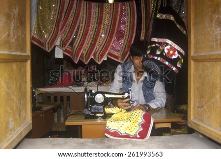 Man sewing Bei Aprons in Bei Village in Dali, Yunnan Province, People\'s Republic of China