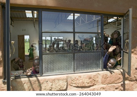 Karimba School with school children in classroom waving to camera in North Kenya, Africa