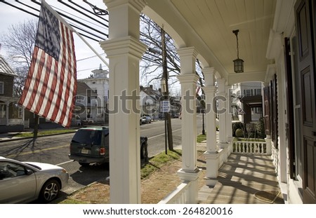 American flag being displayed on porch of home on Main Street of Vincentown, New Jersey