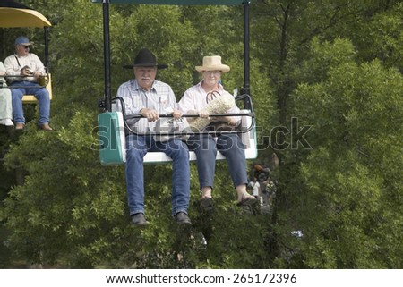 Cowboy couple on chair-lift at Iowa State Fair, Des Moines, Iowa, August, 2007