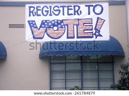 Large hand painted sign reads Register to Vote, CA
