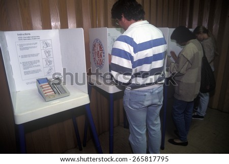 Voters and voting booths in a polling place, CA