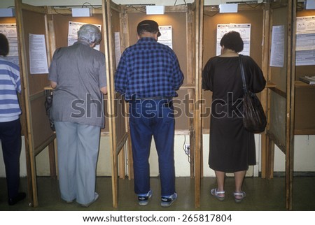 Voters and voting booths in a polling place, CA