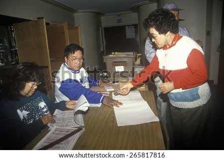 Election volunteers assisting voters in a polling place, CA