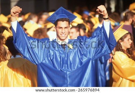 A high school graduate in victory pose, Providence, RI